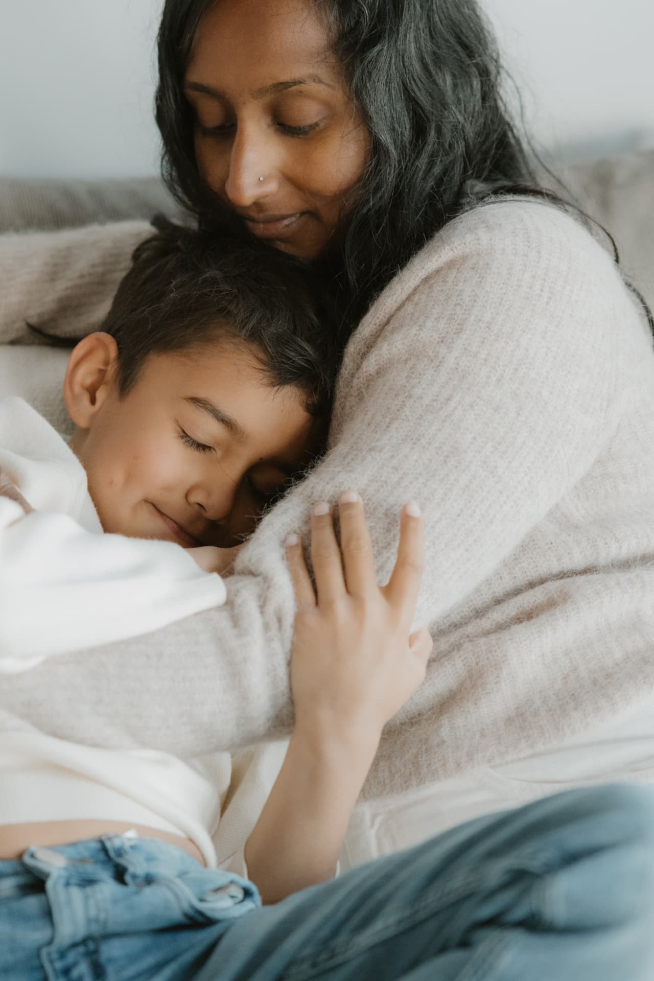Mother embracing her resting child