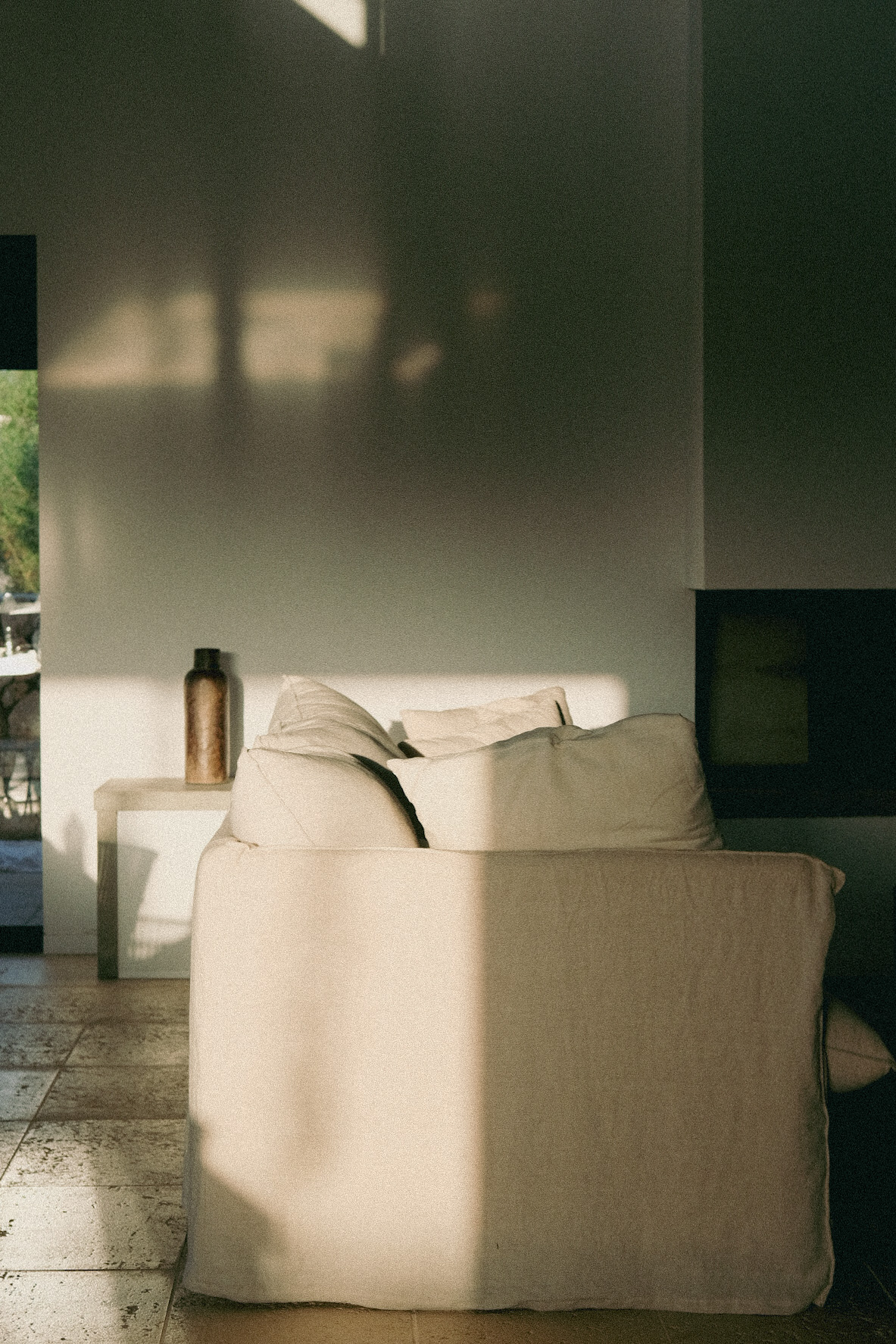 White linen sofa in soft afternoon light and shadow